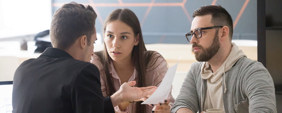 Executor discussing issues with heirs at desk