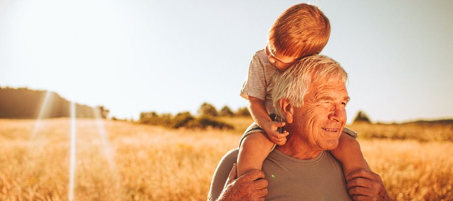Grandfather and grandson heir in field